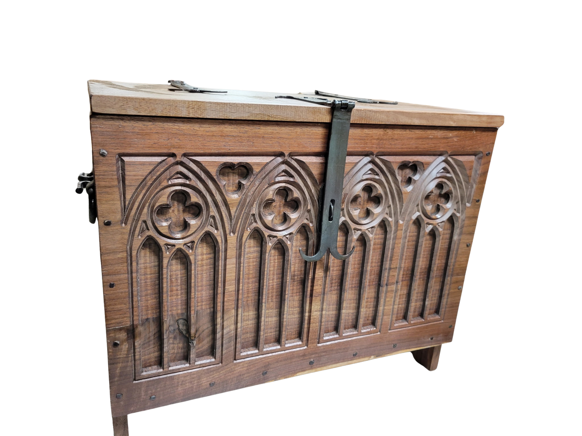 Walnut 6 board chest with carved quatrefoil designs and hand forged hardware.
