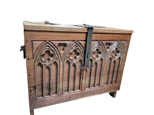Walnut 6 board chest with carved quatrefoil designs and hand forged hardware.